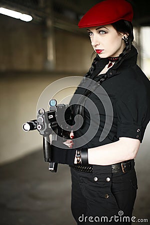 Sexy young woman with gun