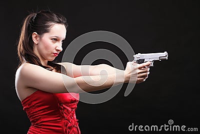 Sexy young woman - gun on black background