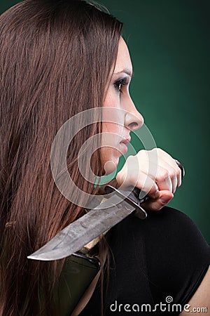 Sexy young woman long hair - gun knife