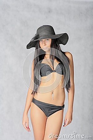 SExy young women in black hat and bikini