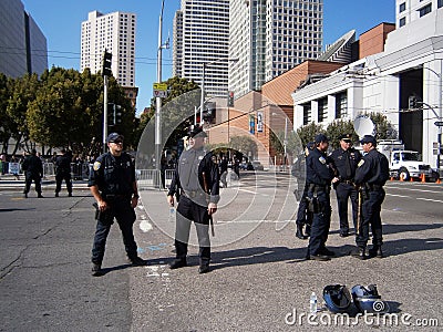 SFPD Police officers stand on street talking as protesters of Ma