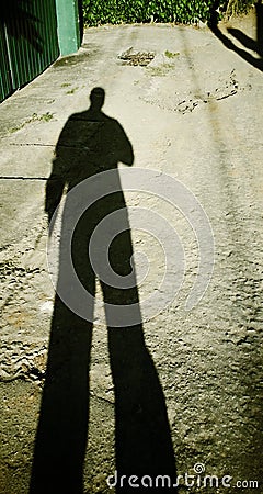 Shadow of a man coming home