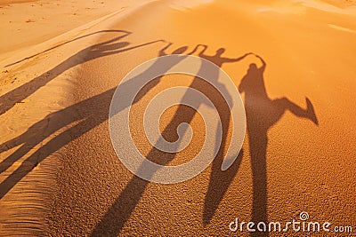 Shadow silhouettes of four people in the desert