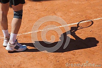 Shadow of a tennis player on court