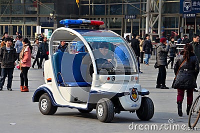 Shanghai Police golf cart buggy vehicle outside railway station, China