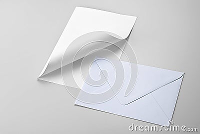 Sheet of paper with curled corner and envelope