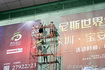 Shenzhen, China: installation of advertising signs