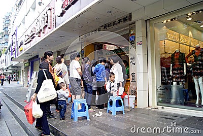 Shenzhen china: people are waiting in line in the front of the shop