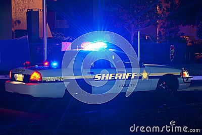 Sheriff car at night with lights on