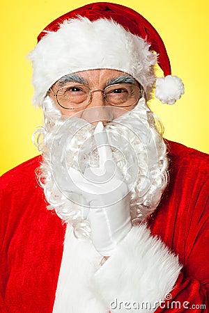 Shh...Aged Santa gesturing silence