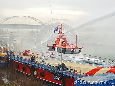 Ship melts the ice by steam gun in the harbor of Gorinchem