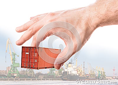 Shipping container in hand above port