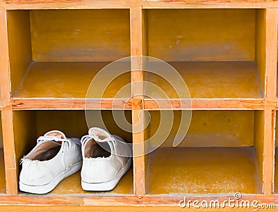 Shoes, boots stand on a rack