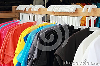 Shop shirts colorful fabric hanging on a rack.