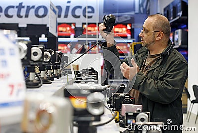 Shopping for digital photo cameras in supermarket