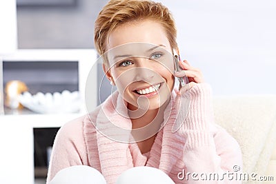 Short hair blonde woman on phone call smiling