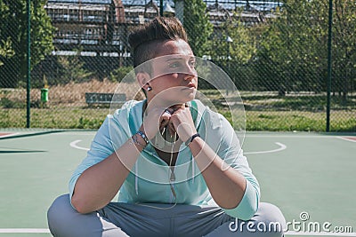 Short hair girl in a basketball playground
