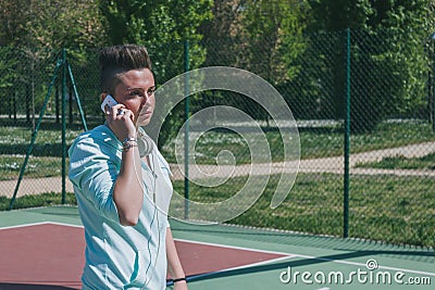 Short hair girl talking on phone in a basketball playground