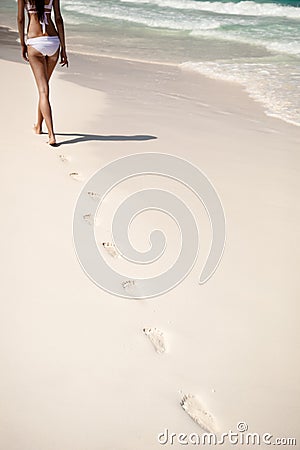 Shot of footprints with woman walks on the tropical beach
