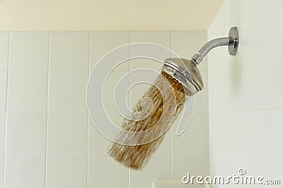 Shower head with dirt pouring out of it