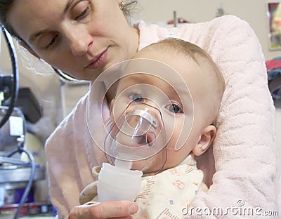 Sick baby with nebulizer mask