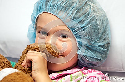 Sick child wearing surgical cap