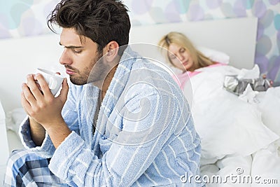http://thumbs.dreamstime.com/x/sick-man-drinking-coffee-bed-woman-sleeping-background-home-men-women-35916147.jpg
