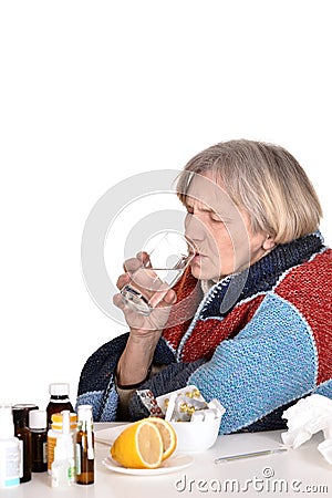 Sick old woman drinks water