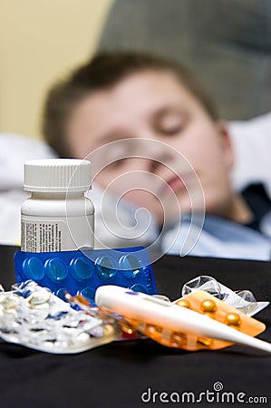 Sick teenage boy and medicines