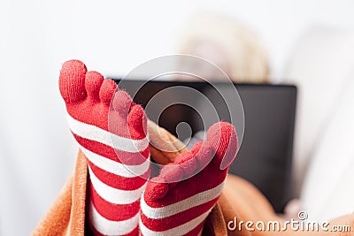 Sick women in funny toesocks on couch