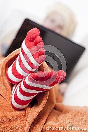 Sick women in funny toesocks on couch