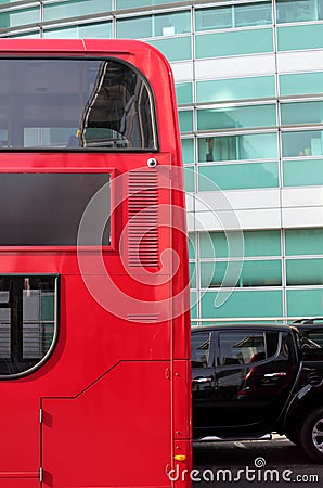 Side of Red London Double Decker Bus and Black Car
