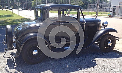 Side View of black 1940 s Ford antique car.