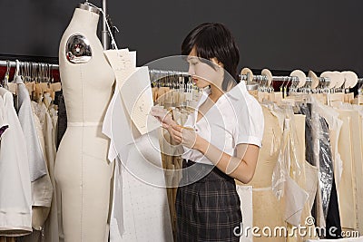 Side view of woman working in her clothing store