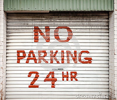 Sign on Lane Garage Door Stating NO PARKING 24 HR