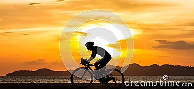 Silhouette biking man at the beach