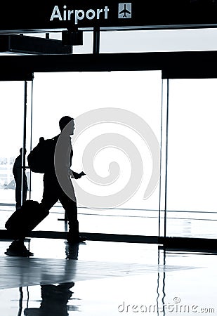 Silhouette of business man walking in airport