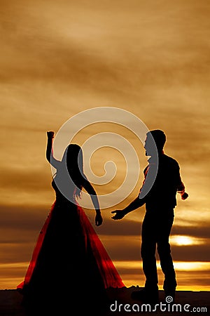 Silhouette couple dancing reach out