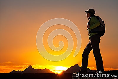 Silhouette of female hiker at sunset.