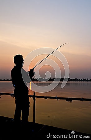 Silhouette of a man fishing