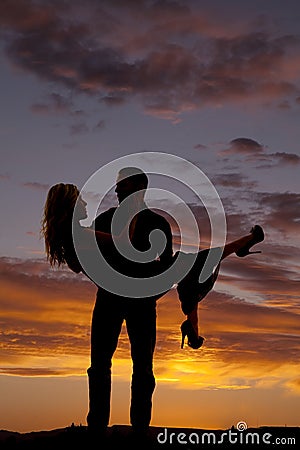 Silhouette man lifting woman look at each other