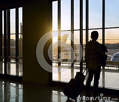 Silhouette of man near window in airport