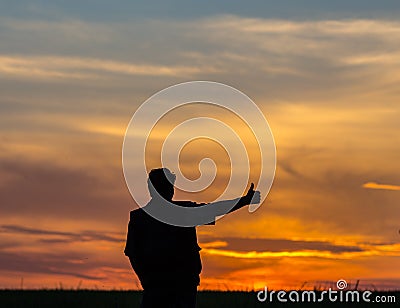 Silhouette of man standing in a field