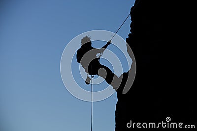 Silhouette rock climbing