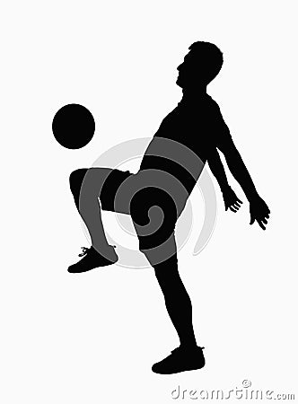 Silhouette of soccer player practicing juggling the ball.