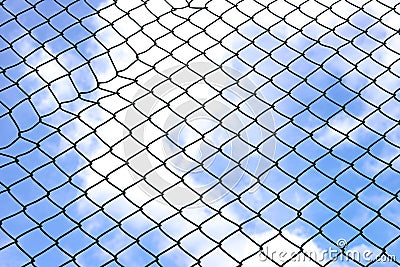 Silhouette wired fence with blur cloud and blue sky