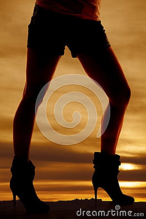 Silhouette woman legs heels facing side