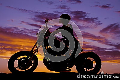 Silhouette woman motorcycle sit elbow on tank