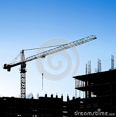 Silhouettes of a construction crane and building