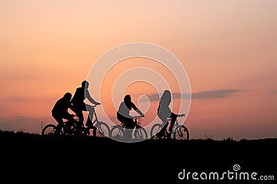 Silhouettes of a family on a bikes